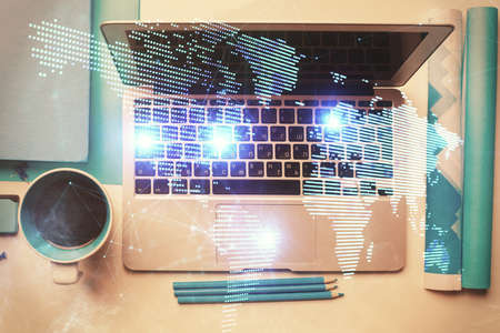 Social network hologram drawings over computer on the desktop background. Top view. Multi exposure. Concept of people connection.の写真素材