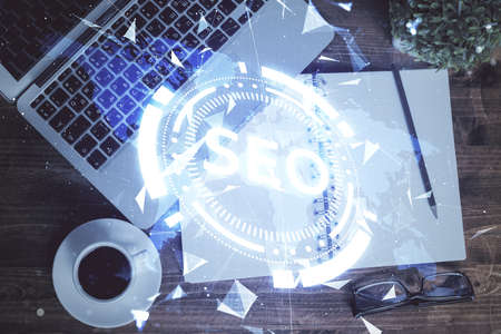 Double exposure of SEO drawing over study table background with computer. Concept of search. Top...