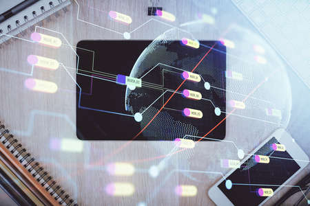 Double exposure of map hologram drawing over desktop. Top view. International connection concept.の写真素材