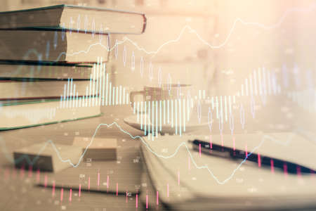 Double exposure of financial chart drawing and desktop with coffee and items on table background....