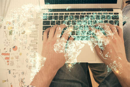 Double exposure of man's hands typing over computer keyboard and social network theme hologram drawing. Top view. People connection web concept.の写真素材