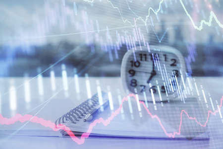 Multi exposure of financial graph drawings and desk with open notebook background. Concept of forex
