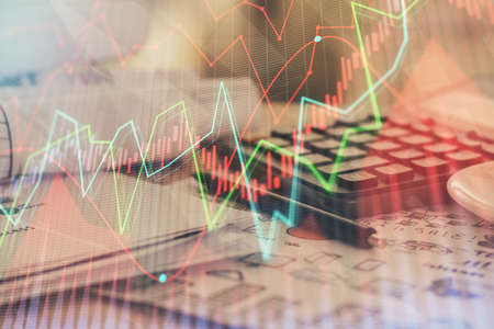 Double exposure of financial chart drawings and desk with open notebook background. Concept of forex...