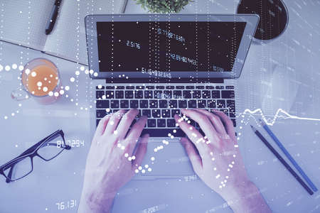 Multi exposure of man's hands typing over computer keyboard and data theme hologram drawing. Top...