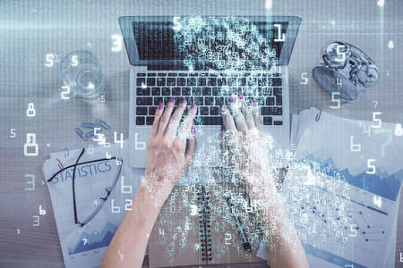 Double exposure of woman hands working on computer and data theme hologram drawing. Top View....