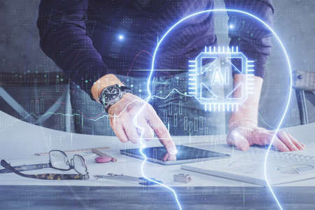 Double exposure of man's hand holding and using a digital device and brain hologram drawing. Data...