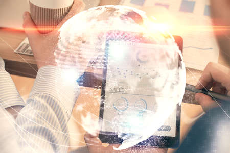 Double exposure of man's hands holding and using a phone and international business theme drawing.の写真素材