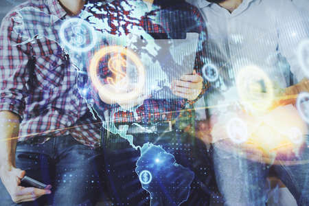 Double exposure of forex graph drawing and man and woman working together holding and using a mobile device. Trade concept.の写真素材