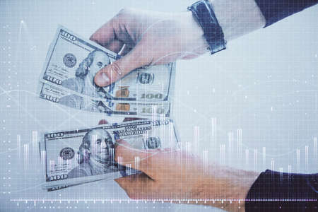 Multi exposure of financial graph drawing hologram and USA dollars bills and man hands. Analysis concept.の写真素材