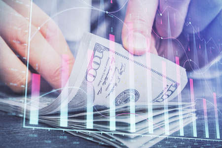 Multi exposure of forex graph drawing hologram and USA dollars bills and man hands. Technical...