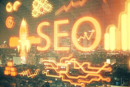 SEO hologram on city view with skyscrapers background double exposure. Search optimization concept.の写真素材