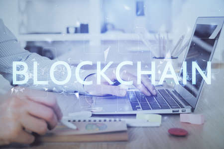 Blockchain theme hud with man working on computer on background. Concept of crypto chain. Double...