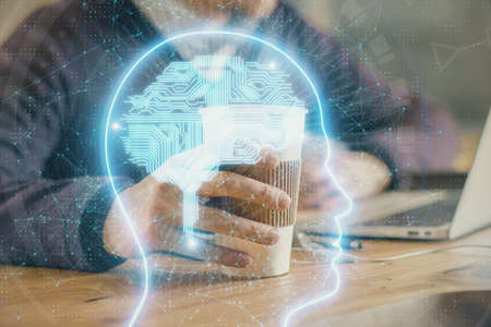 Businessman with computer background with brain theme hologram. Concept of brainstorm. Multi...