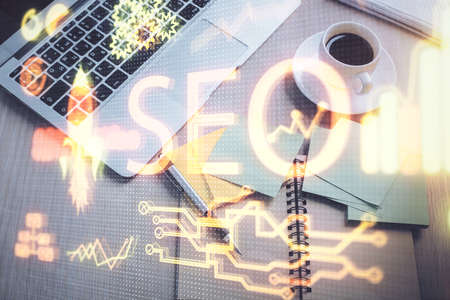 Double exposure of SEO drawing over study table background with computer. Concept of search. Top view.の写真素材