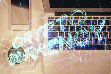 Blockchain theme hologram drawings over computer on the desktop background. Top view. Double...