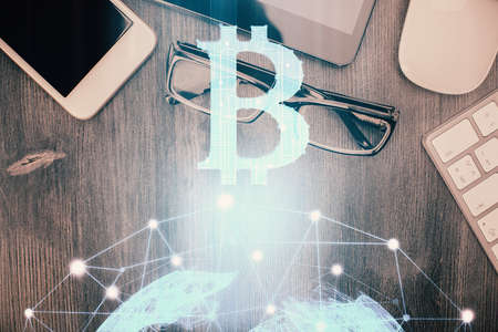 Double exposure of blockchain theme hologram over table with phone. Top view. Crypto technology concept.の写真素材