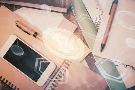 Double exposure of blockchain theme hologram over table with phone. Top view. Crypto technology concept.の写真素材