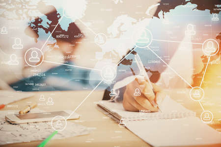 Double exposure of social network theme drawing over people taking notes background. Concept of human connectionの写真素材