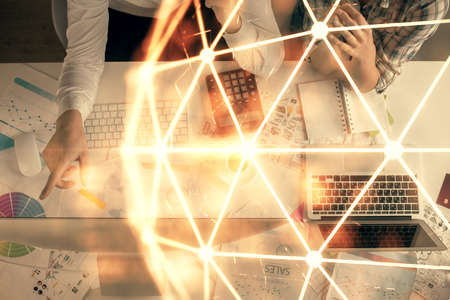 Double exposure of man and woman working together and social network theme hologram drawing....