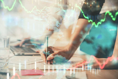 Multi exposure of woman hands typing on computer and financial chart hologram drawing. Stock market...