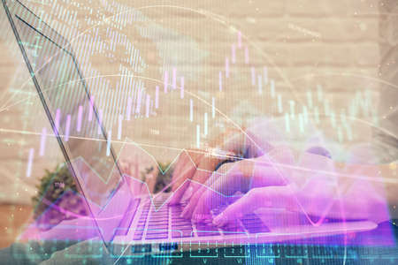 Multi exposure of woman hands typing on computer and forex chart hologram drawing. Stock market...