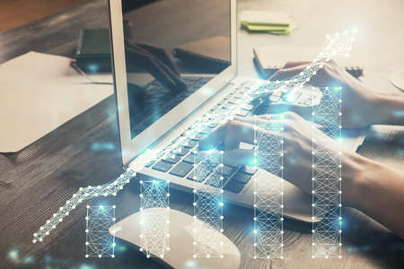 Double exposure of woman hands typing on computer and forex chart hologram drawing. Stock market...