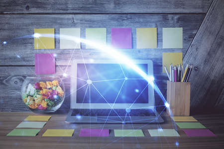 Computer on desktop with social network hologram. Double exposure. Concept of international people...