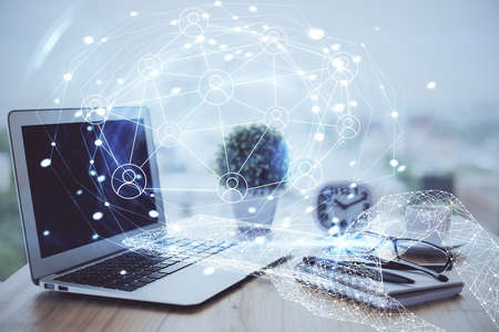 Computer on desktop with social network hologram. Double exposure. Concept of international people...