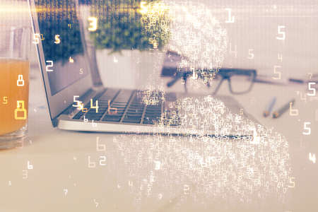 Computer on desktop in office with technology theme hologram. Multi exposure. Tech concept.