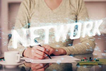 Double exposure of writing hand on background with data solution technology hologram. Ai concept.の写真素材