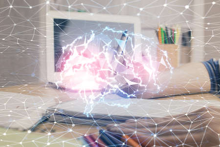 Multi exposure of writing hand on background with brain hologram. Concept of self learning.の写真素材