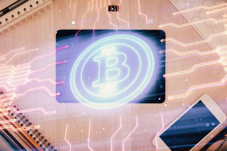 Double exposure of blockchain theme hologram over table with phone. Top view. Crypto technology concept.の写真素材
