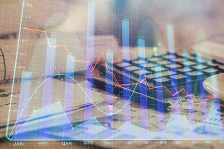 Double exposure of financial chart drawings and desk with open notebook background. Concept of forex marketの写真素材