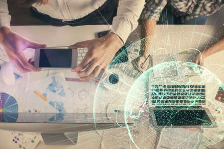 Double exposure of man and woman working together and social network theme hologram drawing....