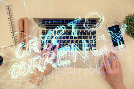 Double exposure of woman hands working on computer and blockchain theme hologram drawing. Top View. bitcoin cryptocurrency concept.の写真素材