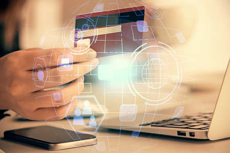 Multi exposure of woman on-line shopping holding a credit card and social network theme drawing....