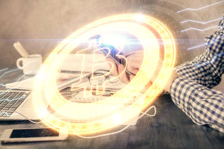 Double exposure of man's hands holding and using a phone and crypto currency blockchain theme...