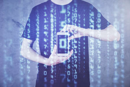 Double exposure of man's hand holding and using a digital device and data theme hologram drawing. Technology concept.の写真素材