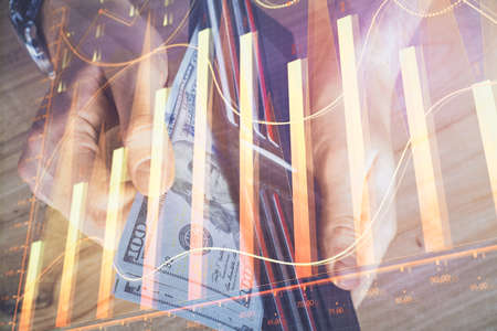 Multi exposure of forex graph drawing hologram and USA dollars bills and man hands. Technical Analysis concept.の写真素材