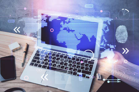 Multi exposure of table with computer and world map hologram. International data network concept.