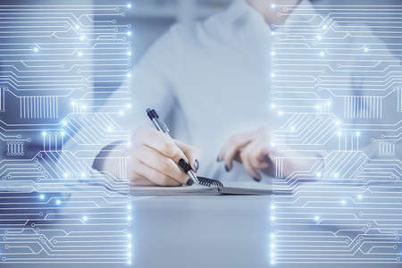 Tech theme hologram over woman's hands taking notes background. Concept of hightech. Double exposureの写真素材
