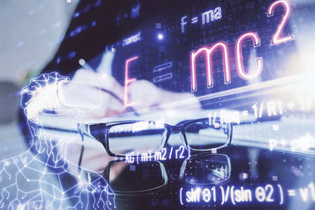 Science formula hologram over woman's hands taking notes background. Concept of study. Double exposureの写真素材