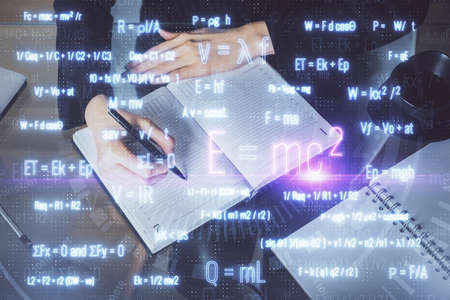 Science formula hologram over woman's hands taking notes background. Concept of study. Double...