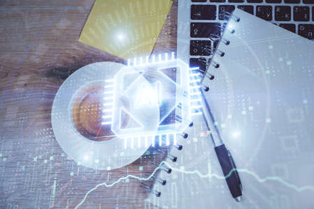 Double exposure of data drawing hologram over topview of study desk background with computer....