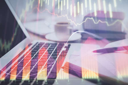 Double exposure of financial chart drawing and desktop with coffee and items on table background....