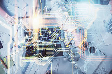 Double exposure of man and woman working together and technology theme world map drawing hologram....