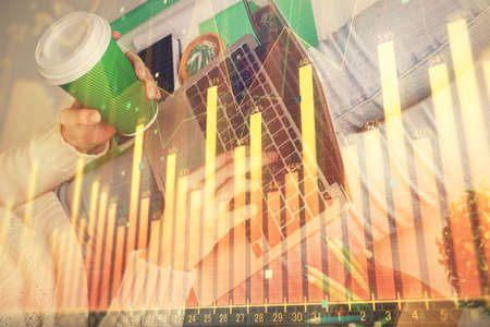 Double exposure of woman hands typing on computer and forex chart hologram drawing. Stock market...