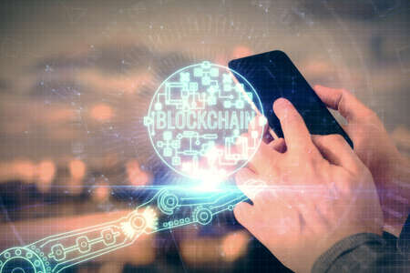 Double exposure of mans hands holding and using a phone and crypto currency blockchain theme drawing.の写真素材
