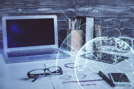 Computer on desktop with social network hologram. Double exposure. Concept of international people connections.の写真素材