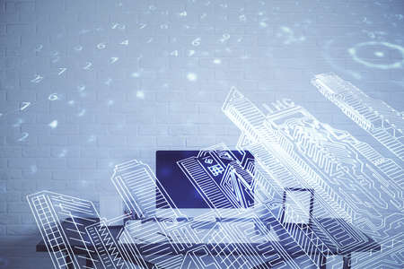 Desktop computer background in office and big town buildings hologram drawing. Double exposure....
